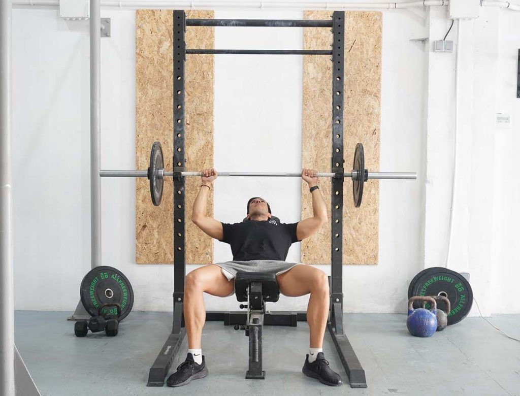 man incline bench press barbell half lifted upper chest workout
